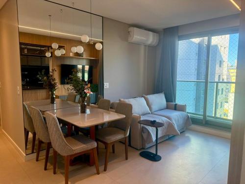 a living room with a table and a couch at Savassi Luxury 2BR Pool and Home Office in Belo Horizonte