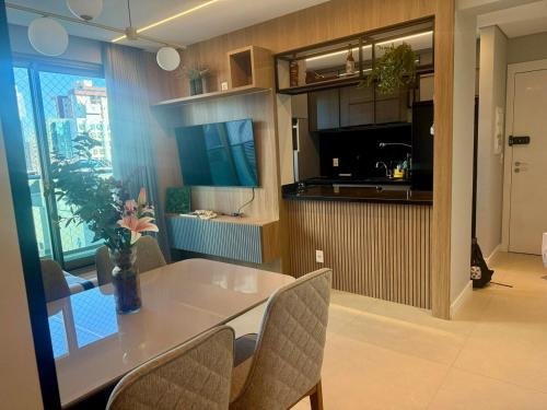 a dining room and kitchen with a table and chairs at Savassi Luxury 2BR Pool and Home Office in Belo Horizonte