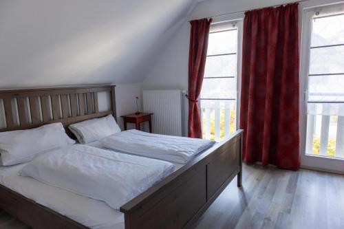 a bedroom with a bed and a large window at Ferienhaus Rügentraum in Glowe