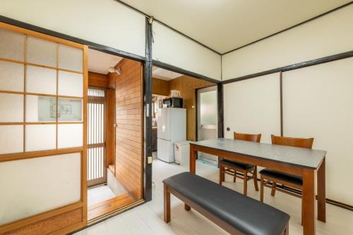 a kitchen and dining room with a table and chairs at A comfortable house with easy access to Osaka city in Osaka