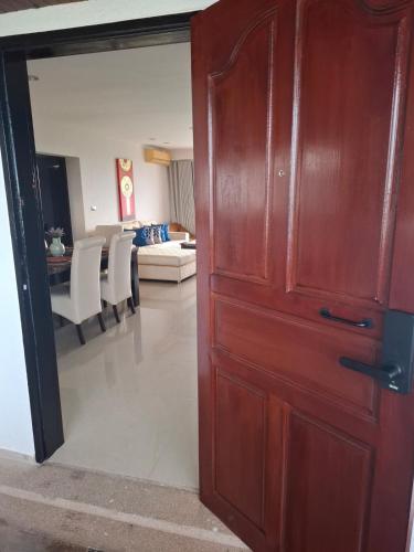 a wooden door in a room with a living room at Apartment on Beach, Stunning Views, Rayong in Ban Phayun