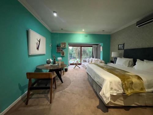 a bedroom with a large bed and a table at The Ridgeback, 4 Bedroom Resplendent Living, Bryanston in Johannesburg