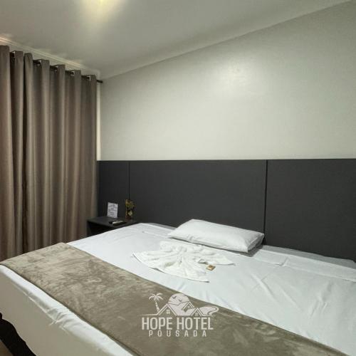 Ένα ή περισσότερα κρεβάτια σε δωμάτιο στο Hope Hotel Pousada