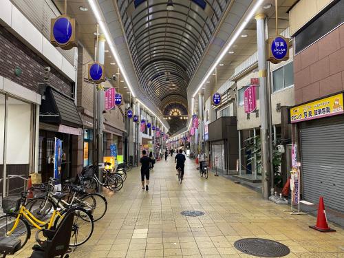 a shopping mall with people walking down the aisle at A comfortable house with easy access to Osaka city in Osaka