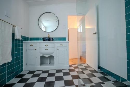 a bathroom with a white vanity and a mirror at Coastal Escape 3BR 2BA Family Retreat in Sellicks Beach