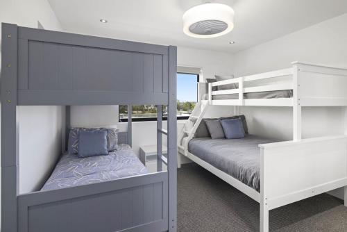 a bedroom with two bunk beds and a bed at Marina Retreat in Sandstone Point