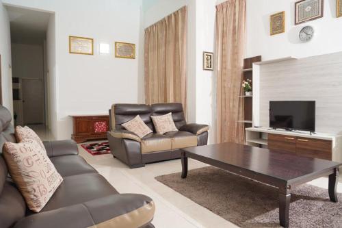 a living room with a couch and a coffee table at Berkat Juta Homestay 2 in Kuantan