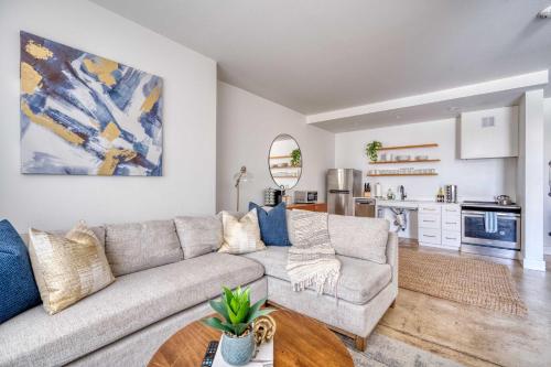 a living room with a couch and a table at Studio Bliss Dual-Queen Stay in Vibrant Alberta in Portland