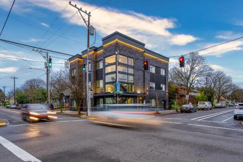 a building on a city street with a traffic light at Stay Portland - City Serenity- Stylish 2-Bed Alberta Haven in Portland