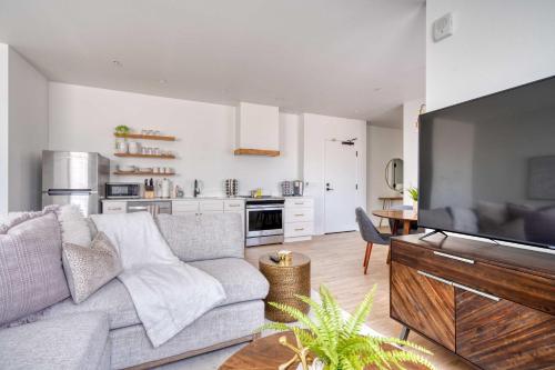 a living room with a couch and a television at Stay Portland - City Serenity- Stylish 2-Bed Alberta Haven in Portland