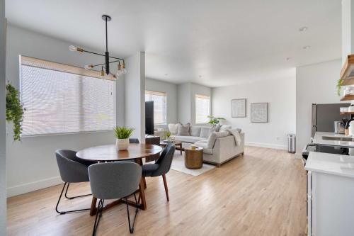 a kitchen and living room with a table and chairs at Stay Portland - City Serenity- Stylish 2-Bed Alberta Haven in Portland