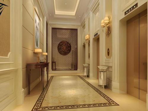 a hallway with a large door in a building at Zhejiang D.H Hotel in Haining