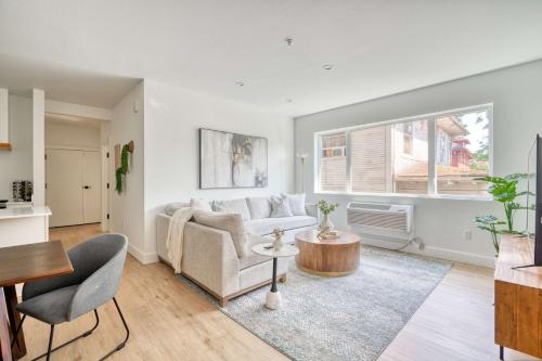 a living room with a couch and a table at N Portland Condo - Walk to Food Bars Music in Portland