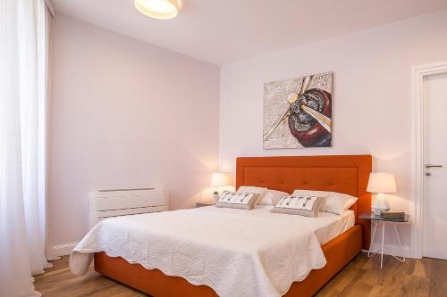 a bedroom with a large bed with white sheets at Piano Nobile Rooms in Split