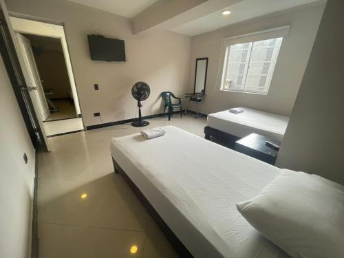 A bed or beds in a room at Hospedaje, Medellín,Turismocolombia-fit,Laureles,Estadio