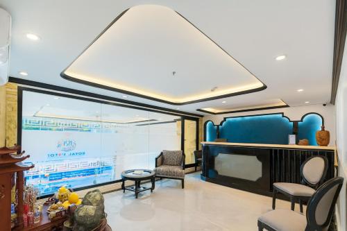 a living room with a large projection screen and chairs at Royal Hotel Hà Nội in Hanoi