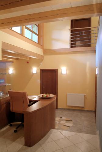 an office with a desk and a chair in a room at Penzion u Pejtrika in Mengusovce