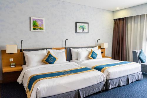 a hotel room with two beds in a room at Ciao SaiGon Hotel & Spa in Ho Chi Minh City