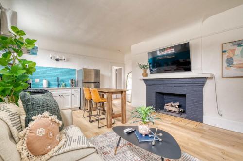 a living room with a couch and a fireplace at Stay Portland - The Garden Bungalow on Broadway - 94 WalkScore in Portland