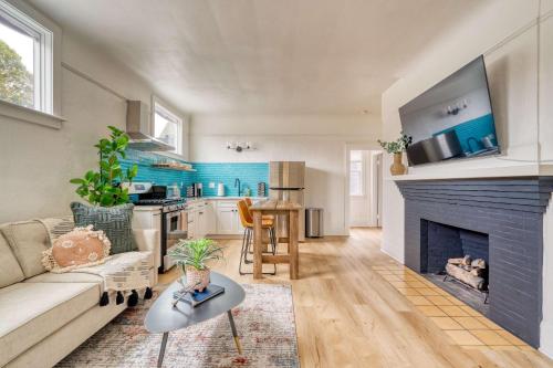 a living room with a couch and a fireplace at Stay Portland - The Garden Bungalow on Broadway - 94 WalkScore in Portland