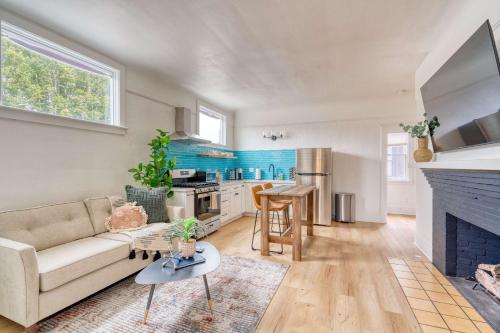 a living room with a couch and a kitchen at Stay Portland - The Garden Bungalow on Broadway - 94 WalkScore in Portland
