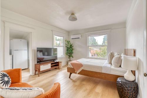 a bedroom with a large bed and a television at Stay Portland - The Sullivan's Gulch Retreat - 94 Walk Score in Portland