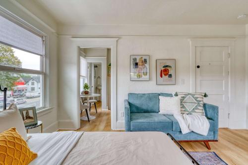a living room with a blue couch and a window at Stay Portland - The Bohemian Bungalow on Broadway - 94 WalkScore in Portland