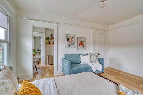 a living room with a blue couch and a table at Stay Portland - The Bohemian Bungalow on Broadway - 94 WalkScore in Portland