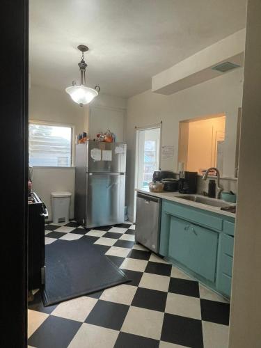 a kitchen with a refrigerator and a checkered floor at Lovely Home at Westminster in Westminster