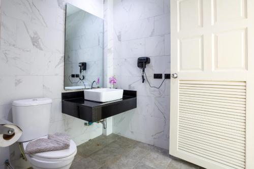 a white bathroom with a sink and a toilet at New! bayfront 2 BR Villa with private pool Nariya V1 - rare find in Phuket in Ban Bang Chak
