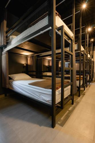 a group of bunk beds in a room at Palm Garden Kuta in Kuta