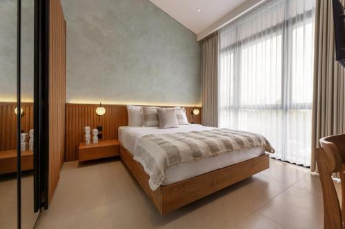 a bedroom with a bed and a large window at Sunset Bliss Villa with Private Pool-North Canggu in Dalung