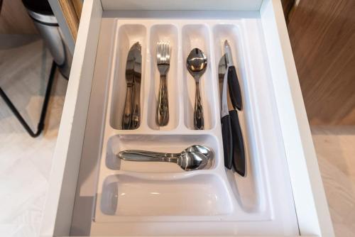 a drawer filled with utensils in a kitchen sink at Brás Downtown Residence Flat in Sao Paulo