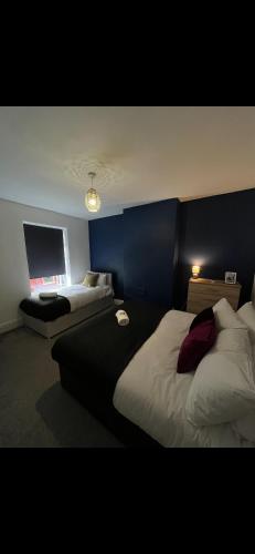 a hotel room with two beds and a flat screen tv at 2BR Apt By Eason Stays Short Lets Warrington in Warrington