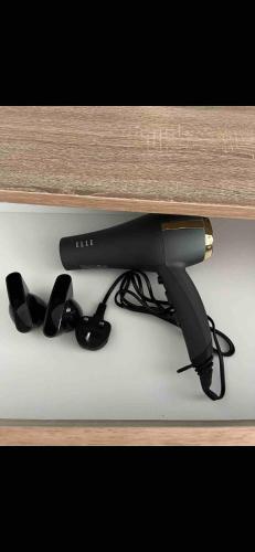 a black hair dryer sitting on top of a table at 2BR Apt By Eason Stays Short Lets Warrington in Warrington