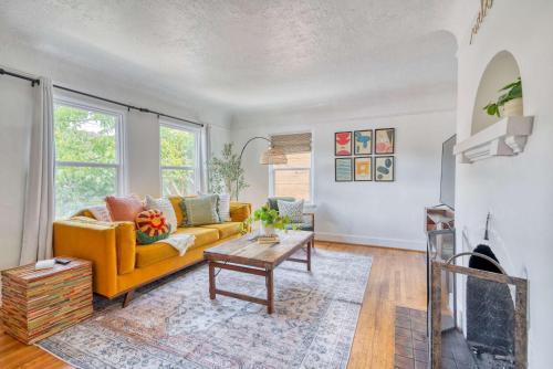 a living room with a yellow couch and a table at Stay Portland - Sedona Vibes in PDX- Walk to Local Shops & Coffee in Portland