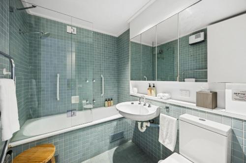 a bathroom with a sink and a toilet and a mirror at Heath Cliff House in Aireys Inlet