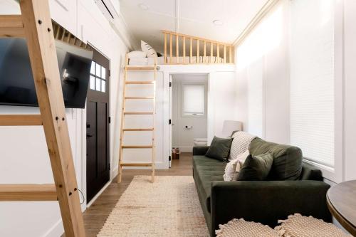 a living room with a couch and a loft bed at Stay Portland - The Graffiti Alley Tiny House - Food, Art & Beer in Portland