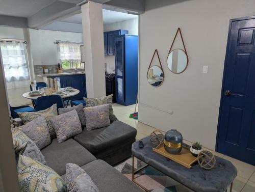 a living room with a couch and a table at Jacqueline's Court in Mount Pleasant