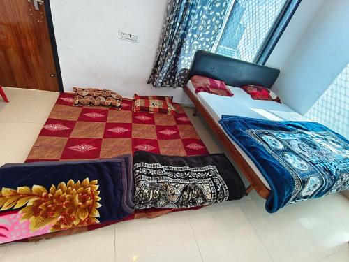 a bedroom with a bed with a quilt on it at Aasha Palace Khatu Shyam Ji in Khātu