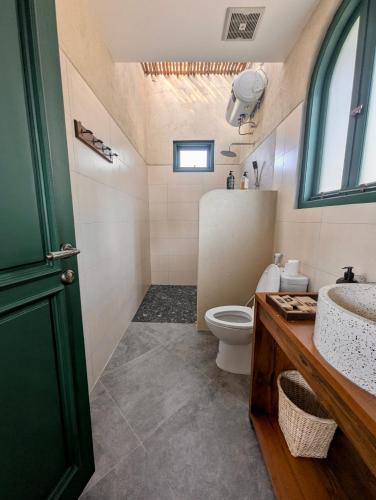 a bathroom with a toilet and a sink at LAWA Bintan Berakit Village Cottage in Berakit