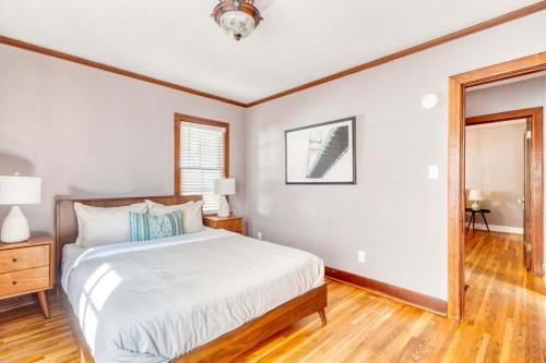 a bedroom with a bed and a wooden floor at Stay Portland - Charming Portland Home in Hollywood District in Portland