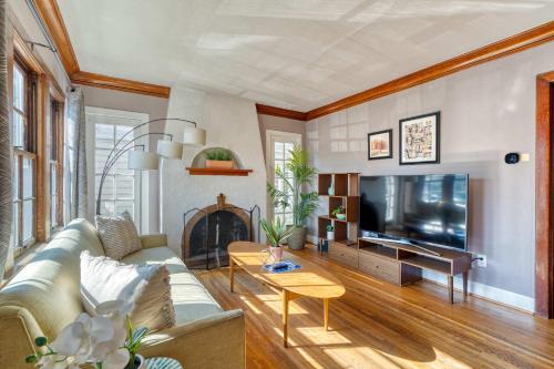 a living room with a couch and a tv at Stay Portland - Charming Portland Home in Hollywood District in Portland