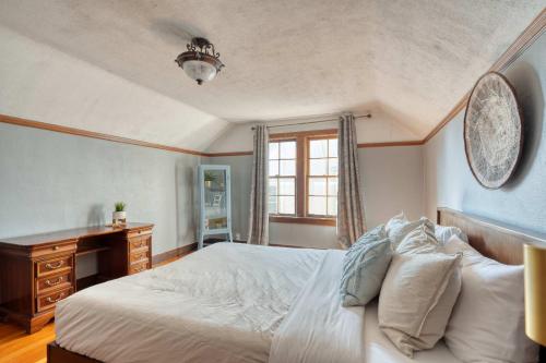 a bedroom with a bed and a desk and a window at Stay Portland - Charming Portland Home in Hollywood District in Portland