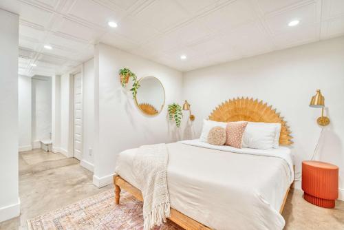 a white bedroom with a large bed and a mirror at Stay Portland - Budget-Friendly Basement Hideaway - 91 WalkScore in Portland