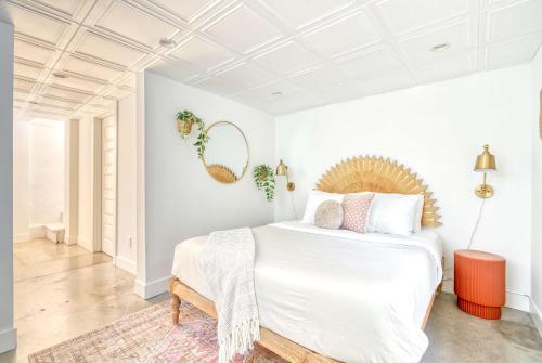 a bedroom with a large white bed with a wooden headboard at Stay Portland - Budget-Friendly Basement Hideaway - 91 WalkScore in Portland