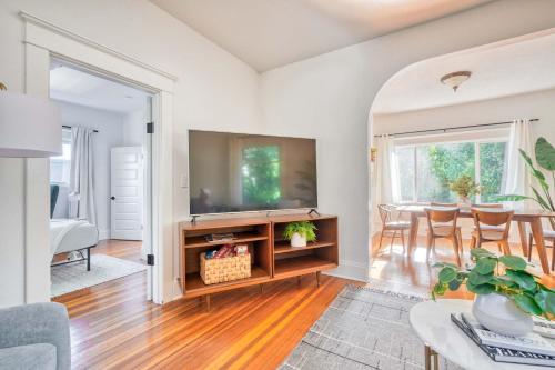 a living room with a tv and a table at Stay Portland - Cute & Charming Portland Home 91 WalkScore in Portland