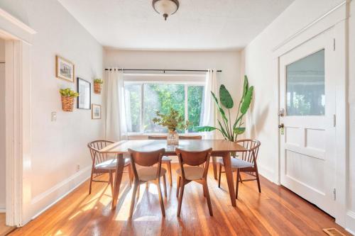 a dining room with a table and chairs and a window at Stay Portland - Cute & Charming Portland Home 91 WalkScore in Portland