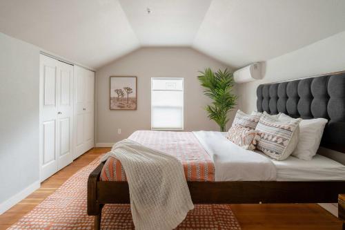 a bedroom with a large bed with a large headboard at Stay Portland - Cozy Attic Hideaway in Laurelhurst in Portland