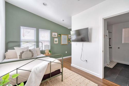 a bedroom with a bed and a tv on a wall at Stay Portland - Urban Cabin Studio - Breweries & Local Eateries in Portland